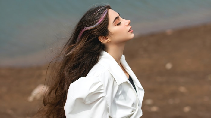 Model with colorful hair on a beach