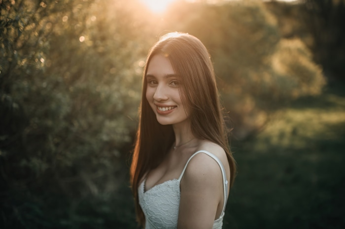 Young woman smiling in sunlight