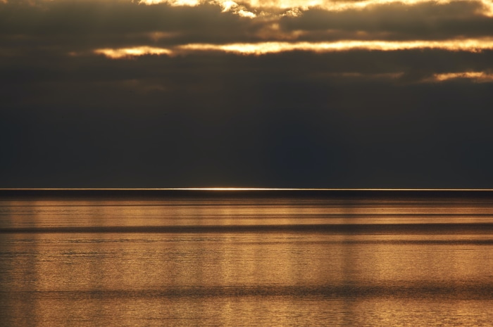 Sunset over the ocean with clouds