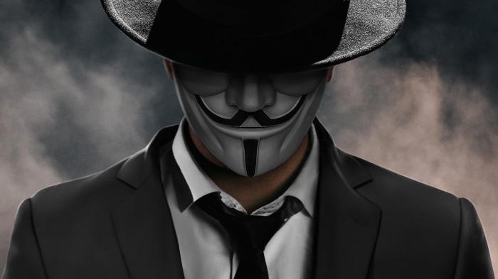 Anonymous figure in a suit and hat