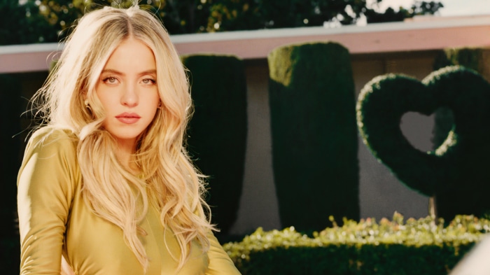 Sydney Sweeney in a yellow dress outdoors