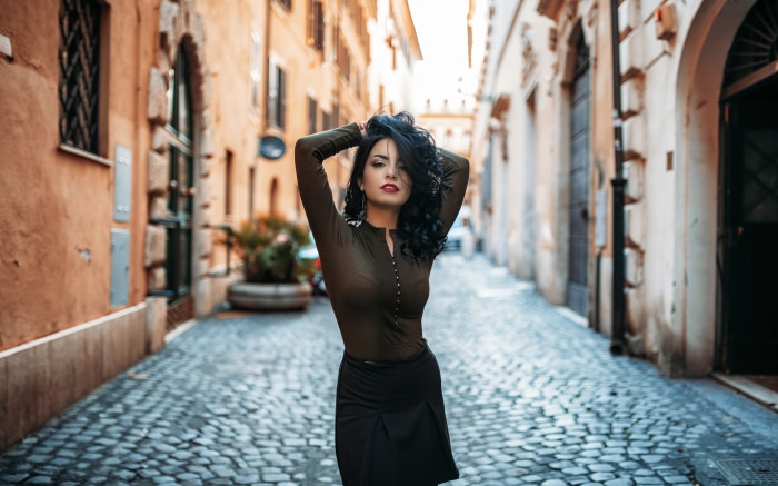 Stylish Woman on Cobblestone Street