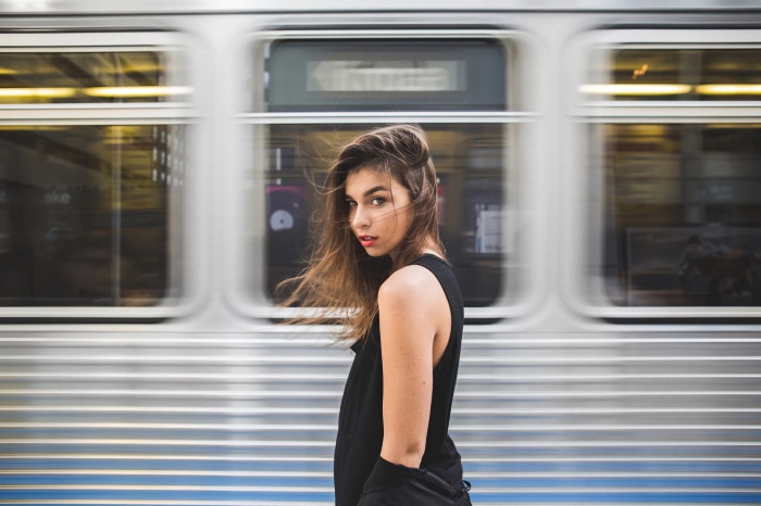 Model posing in front of a moving train