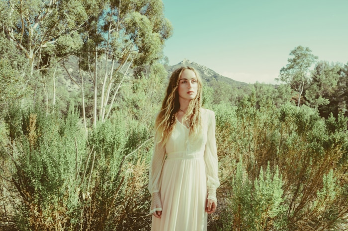 Zella Day in a white dress outdoors