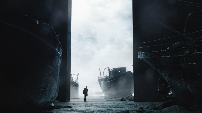 Man standing between abandoned ships