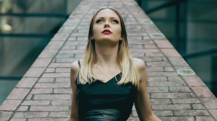 Model in black dress looking up