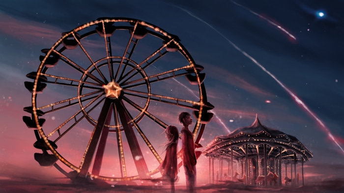 Couple at a Ferris Wheel and Carousel at Night