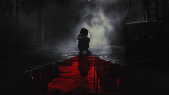 The Batman crouching in smoke with red reflection