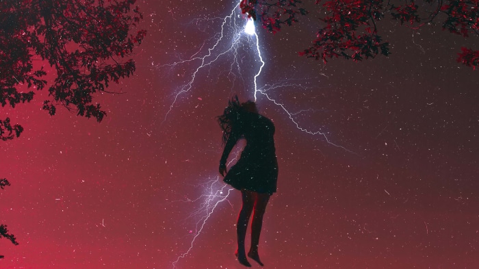 Girl struck by lightning under red sky
