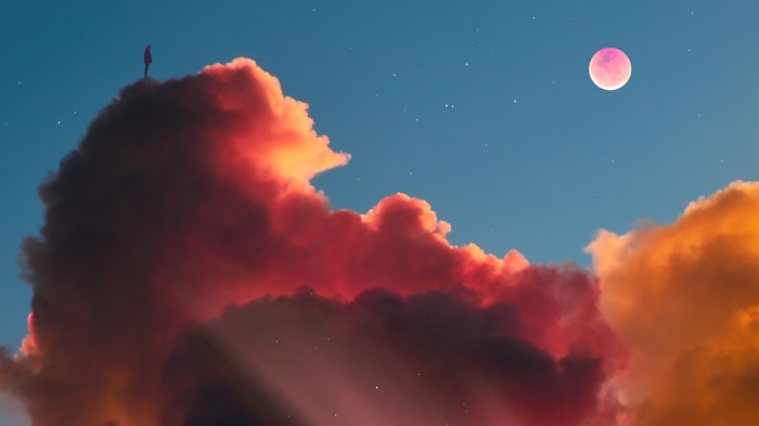 Person standing on clouds with pink moon