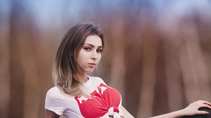 Model with blonde hair wearing a white t-shirt
