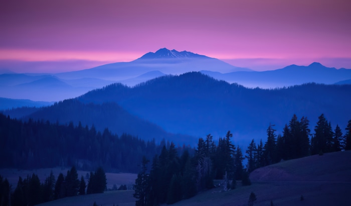 Mountains at sunrise with purple sky