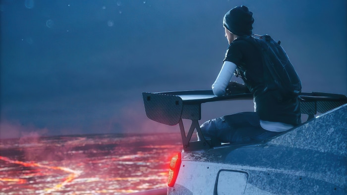 Boy on a car spoiler overlooking a city
