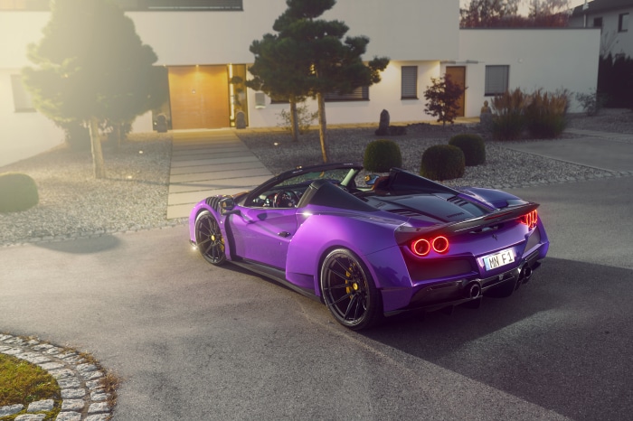Purple Ferrari F8 Spider parked in front of a modern house