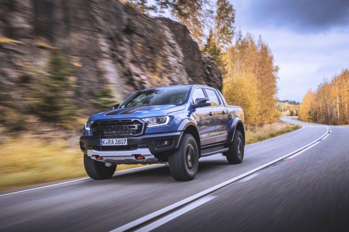 Blue Ford Ranger Raptor driving on a winding road