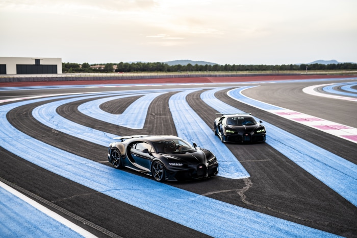 Two black Bugatti Chiron Pur Sport cars on a race track