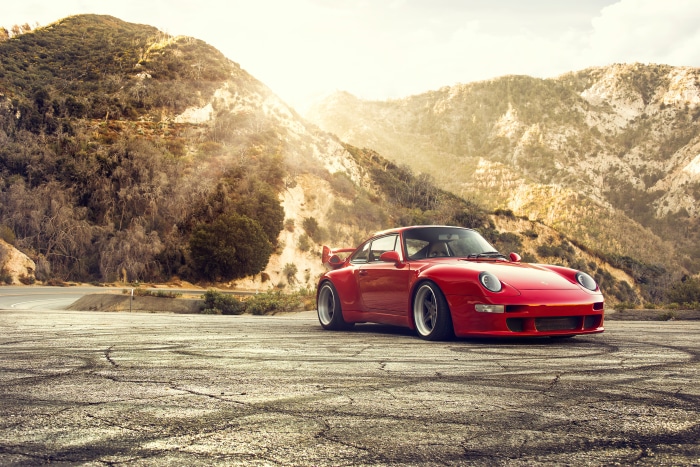 Red Porsche 911 400R on a mountain road