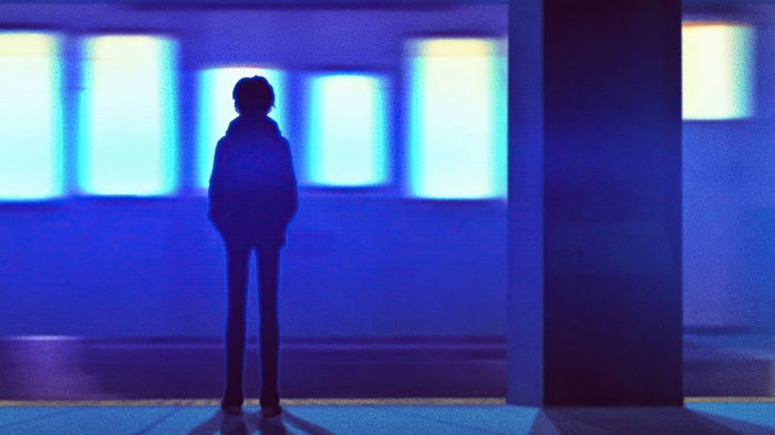 Silhouette of a person on a train platform