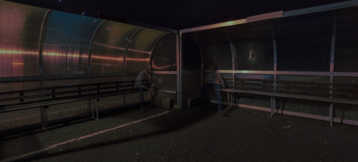 Two people in a covered shelter at night