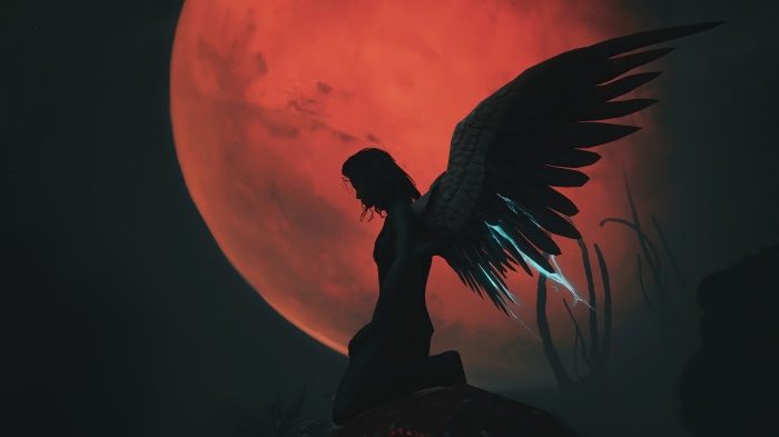 Angel with large wings in front of a red moon