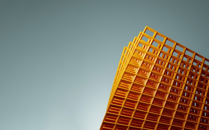 Abstract orange grid structure against a blue sky