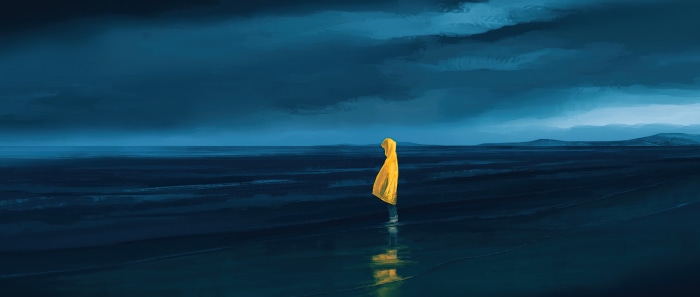 Person in yellow raincoat on a dark beach