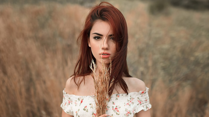 Model with red hair in a field