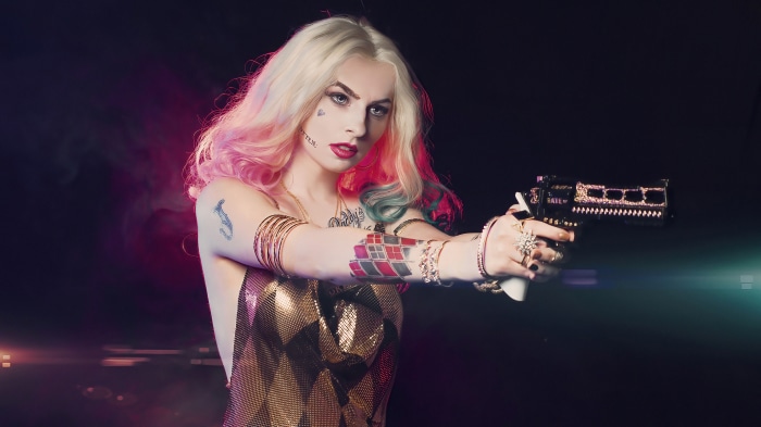 Harley Quinn holding a jeweled gun