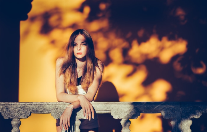 Blonde girl leaning on a railing