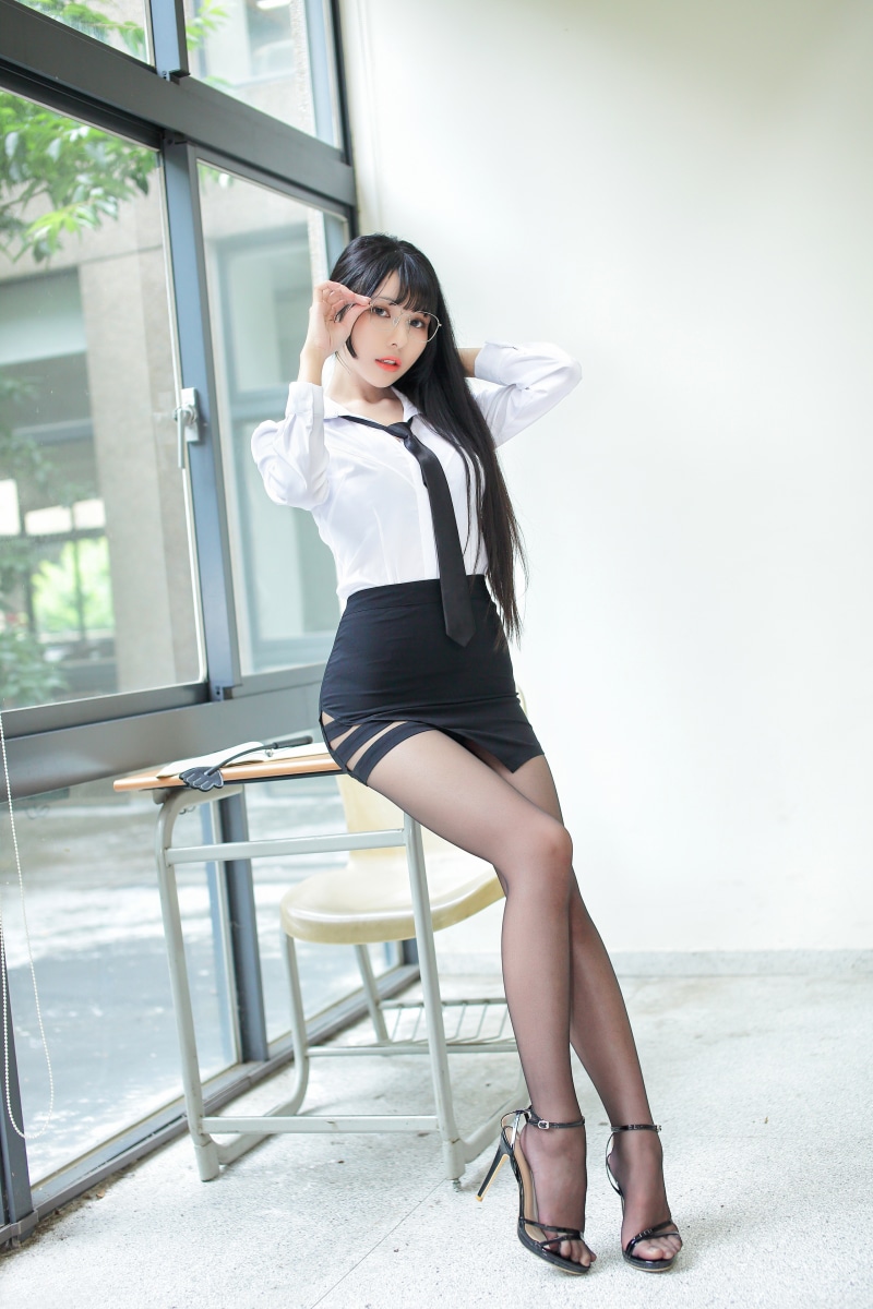 Asian woman in school uniform with glasses