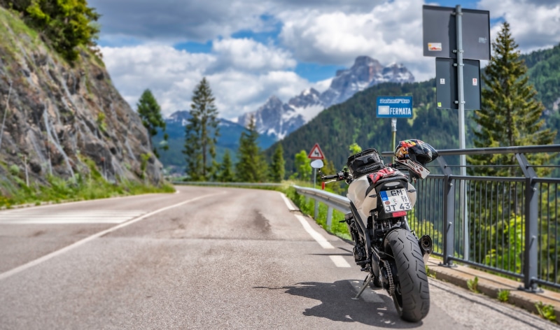 Motorcycle parked on a mountain road in the Dolomites, Italy