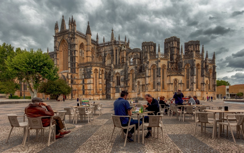 People at Cafe in front of Batalha Monastery, Portugal