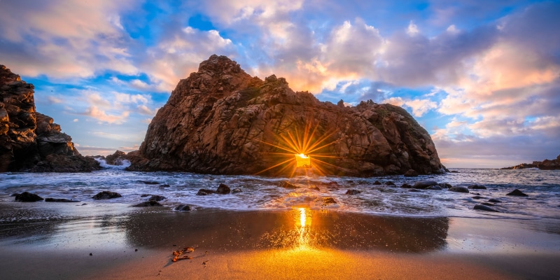 Sunset through Keyhole Arch at Pfeiffer Beach, California