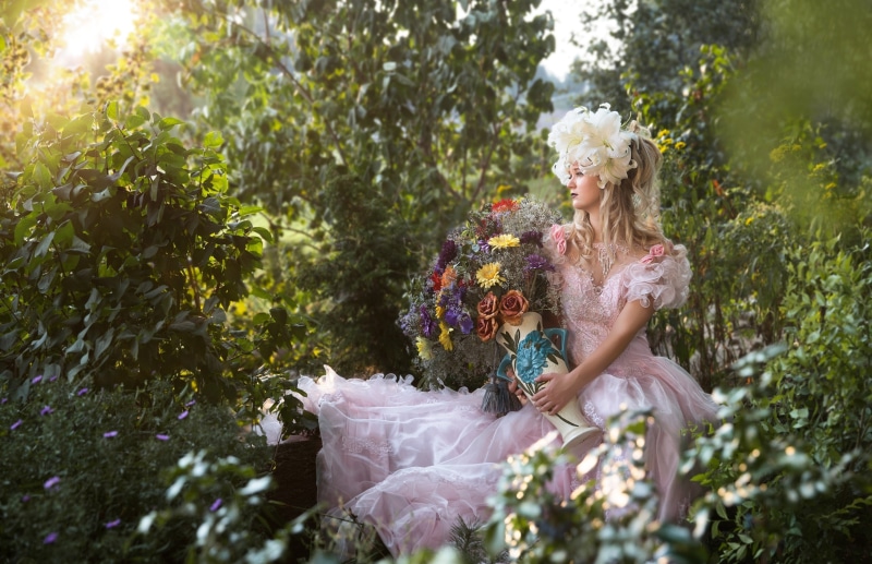 Woman in pink dress with flowers and jug