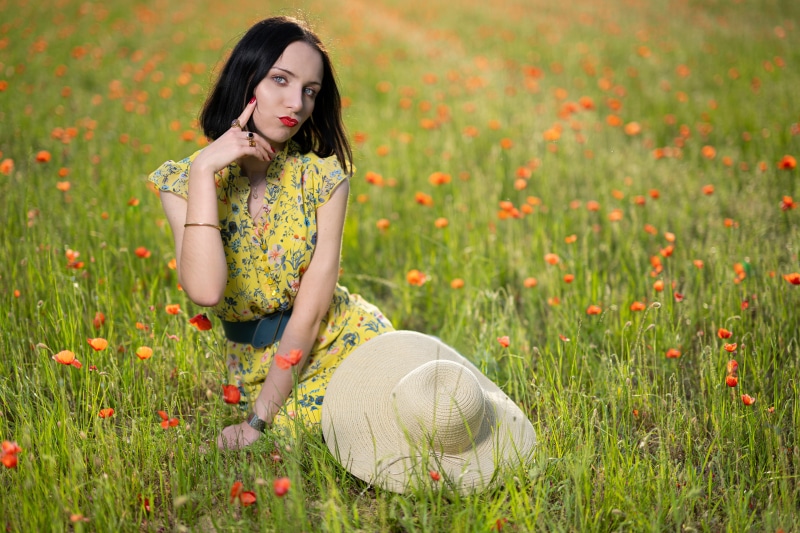 Melanie in a poppy field with a hat