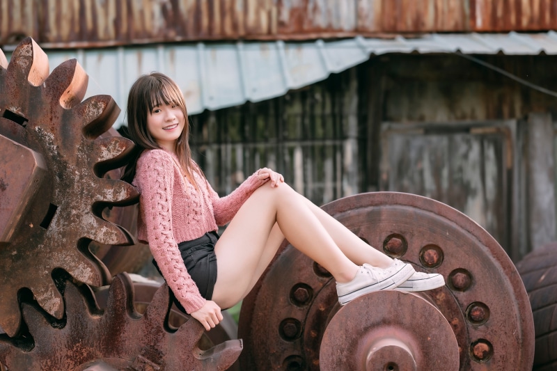 Asian woman sitting on gears
