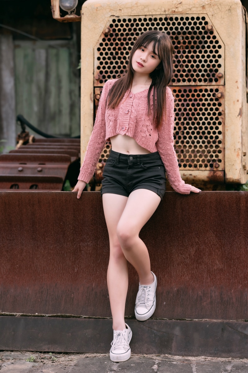 Asian girl in pink cardigan and black shorts
