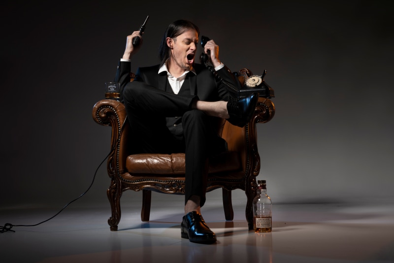 Man in Suit with Pistol and Telephone