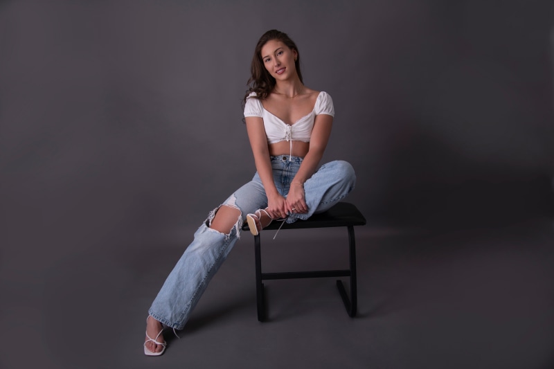 Arianne Vachon sitting on a chair in jeans