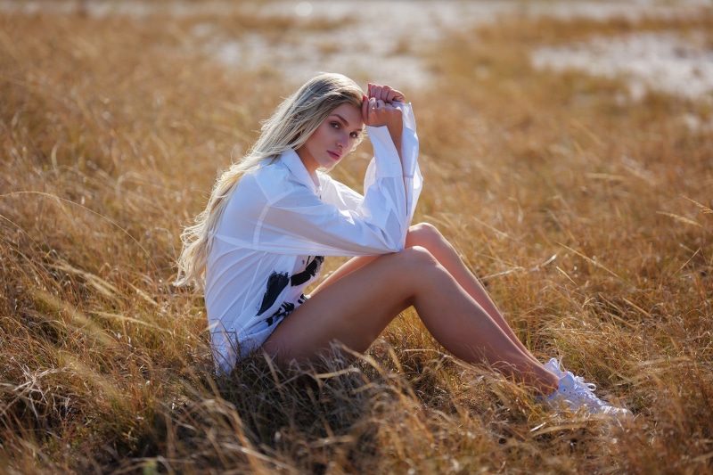Rebecca blonde girl sitting in grass