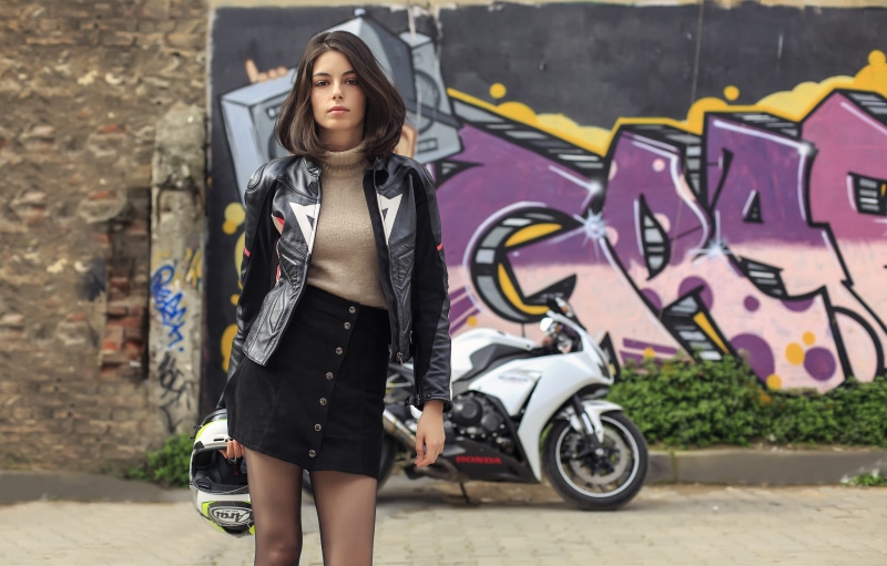 Brunette girl with motorcycle helmet and Honda motorcycle