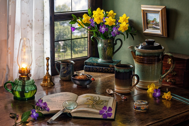 Still life with flowers, book, and lamp