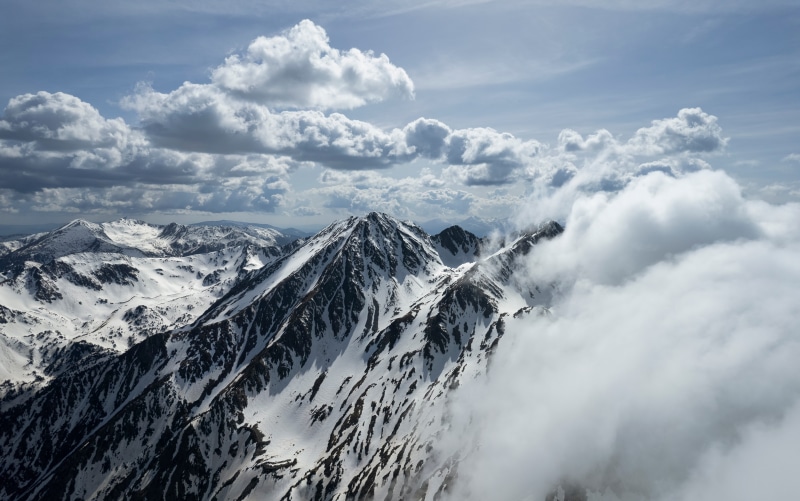 Snow-covered mountains in Andorra with clouds