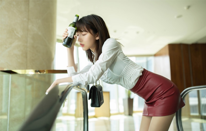 Brunette girl holding a bottle of wine