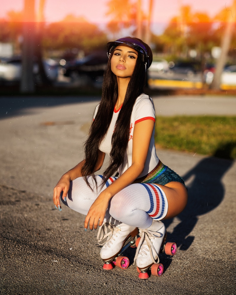 Brunette girl in roller skates and knee highs
