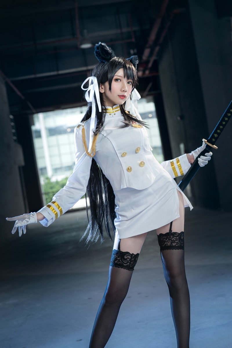 Brunette girl in uniform with sword and stockings