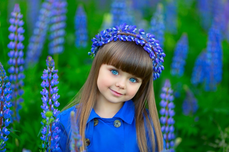 Little girl with blue eyes and flower wreath