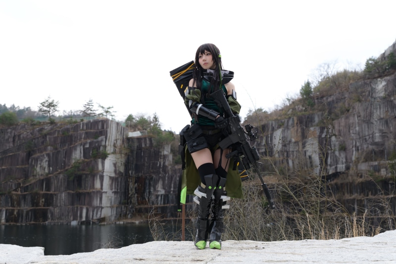 Brunette girl in cosplay with sniper rifle