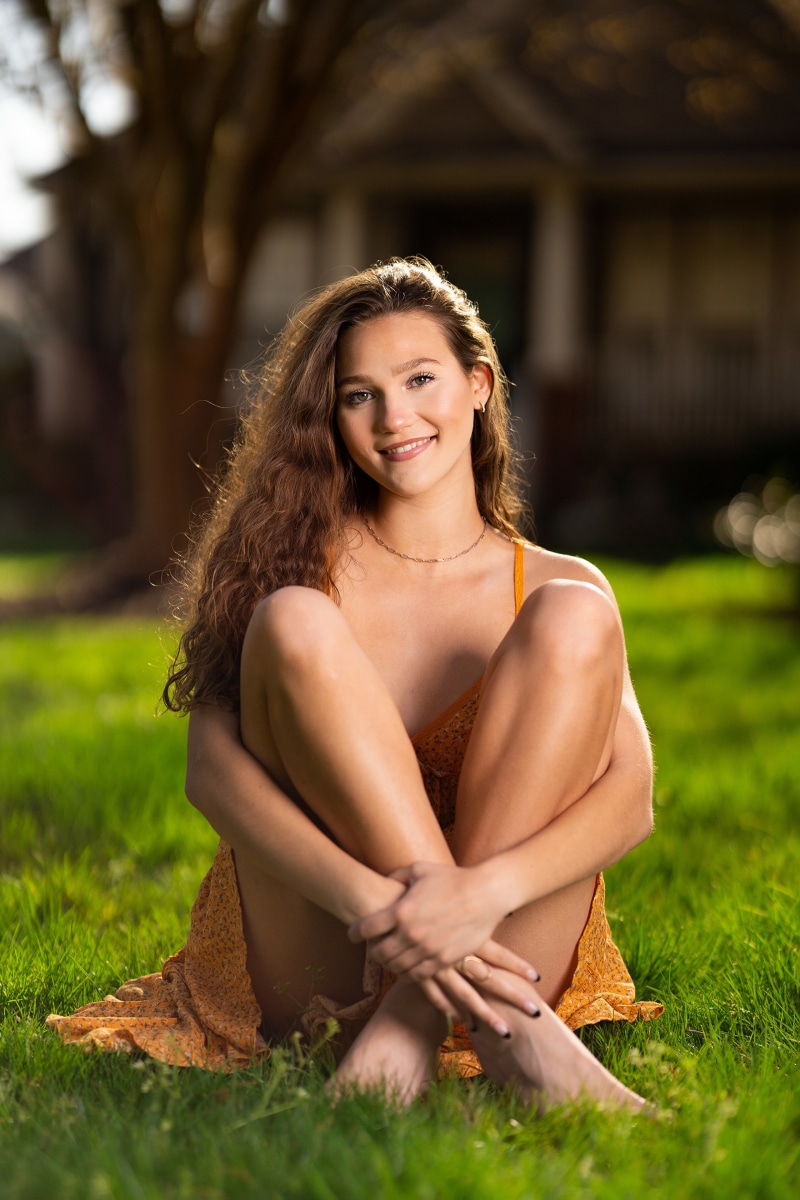 Elizabeth sitting in a grassy field