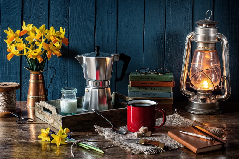 Still-life with daffodils, coffee, and kerosene lamp